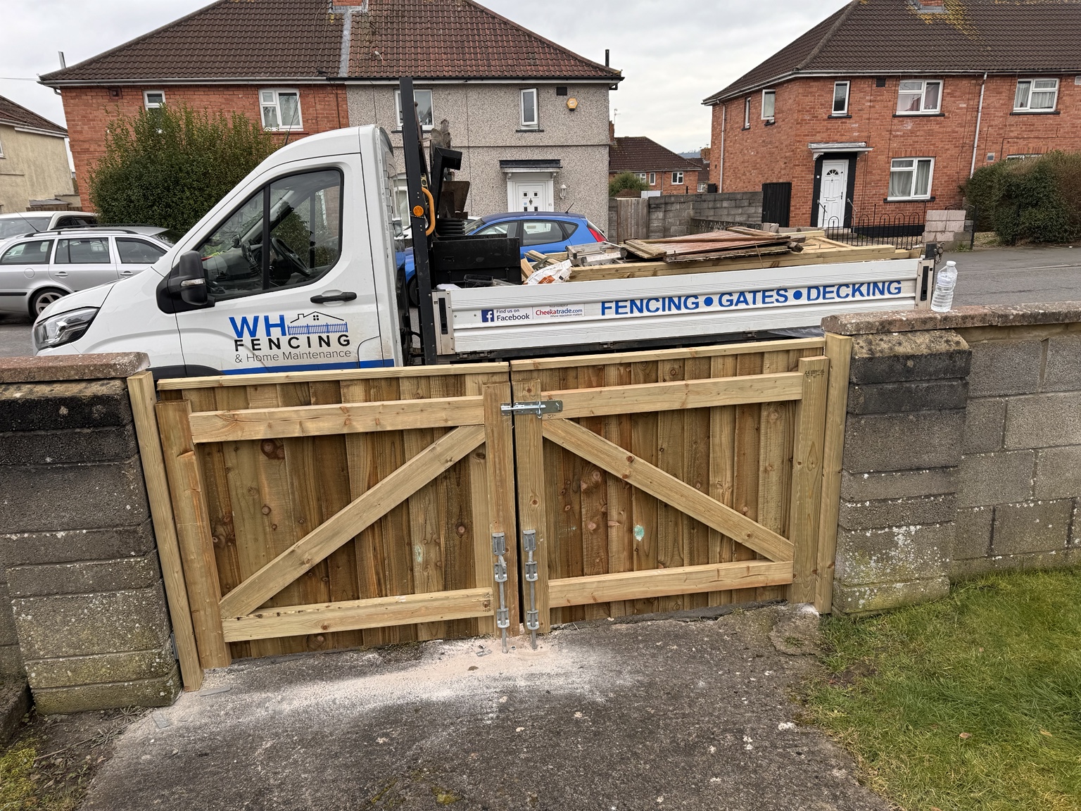 Pair of timber driveway gates with branded work vehicle behind
